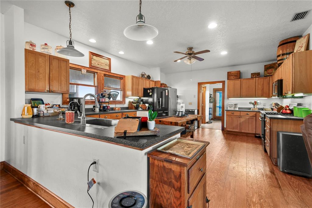 10807 Northwest Lily County Line Road Ona, FL 33865 - Photo 46 of 91 a kitchen with stainless steel appliances granite countertop a sink a stove and a refrigerator