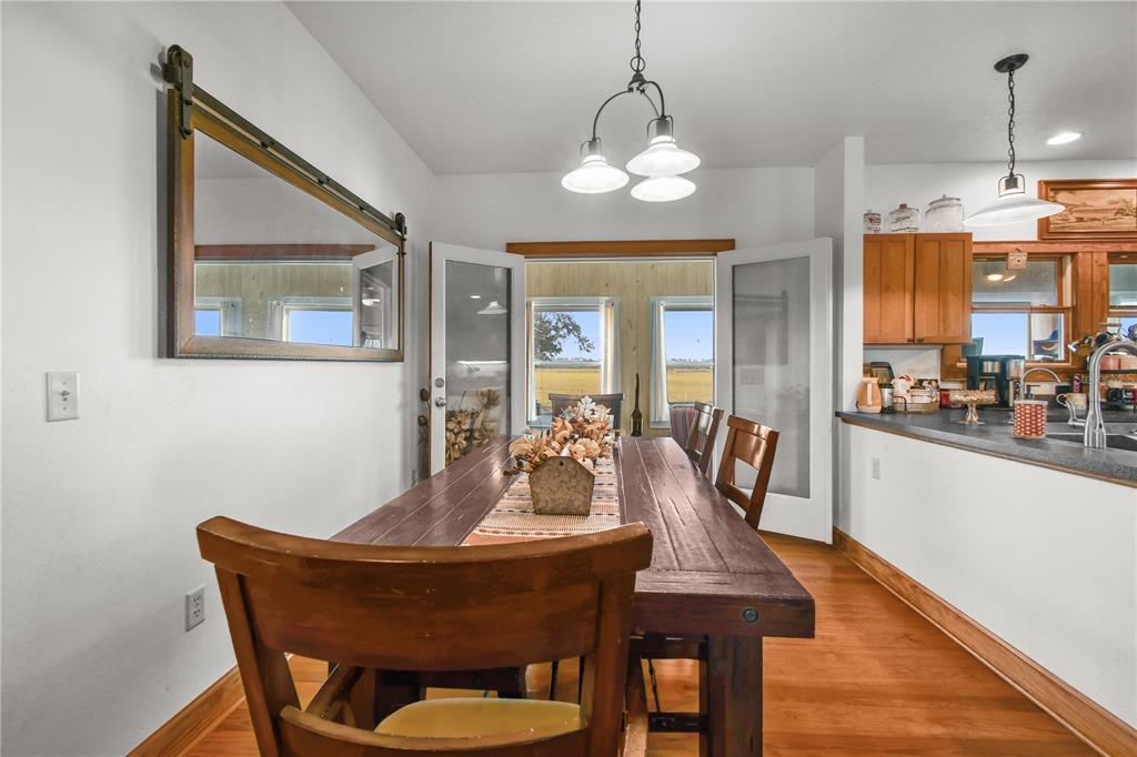 10807 Northwest Lily County Line Road Ona, FL 33865 - Photo 56 of 91 a dining room with furniture a chandelier and wooden floor
