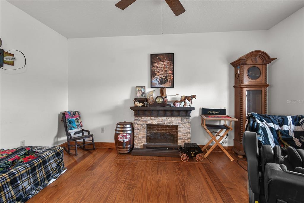 10807 Northwest Lily County Line Road Ona, FL 33865 - Photo 59 of 91 a living room with furniture and a fireplace
