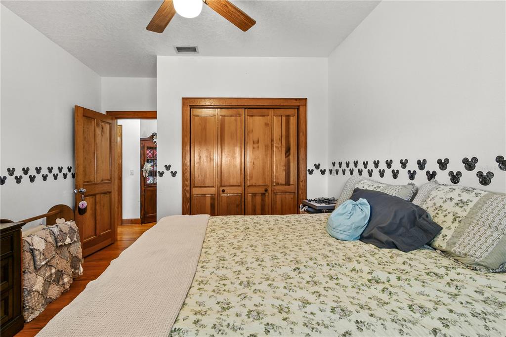 10807 Northwest Lily County Line Road Ona, FL 33865 - Photo 69 of 91 a bedroom with a bed and a chandelier