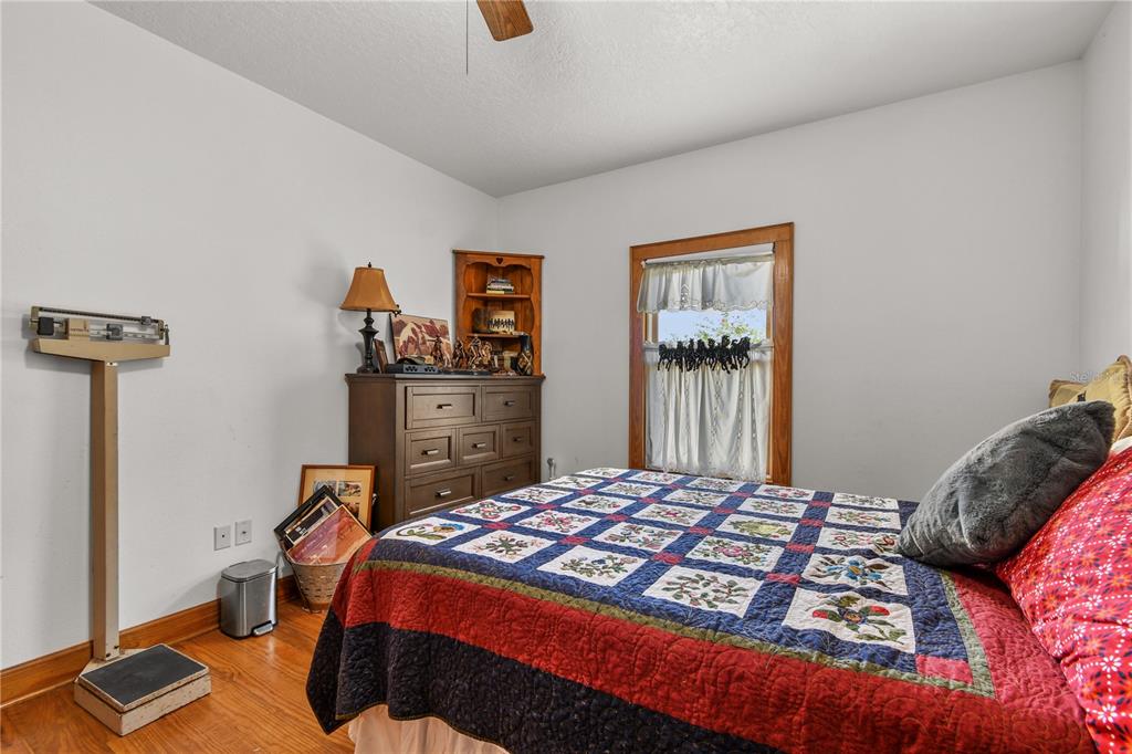 10807 Northwest Lily County Line Road Ona, FL 33865 - Photo 71 of 91 a bedroom with a bed and wooden floor