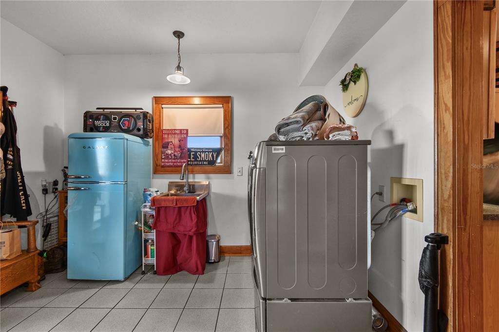 10807 Northwest Lily County Line Road Ona, FL 33865 - Photo 76 of 91 a room with water heater and wooden cabinets