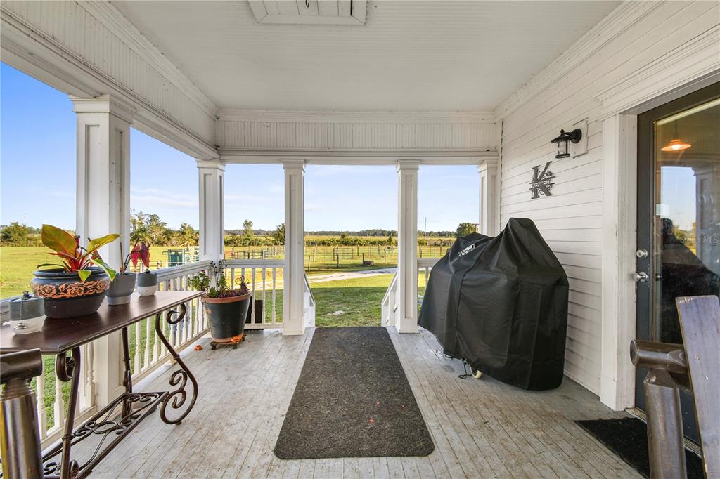 10807 Northwest Lily County Line Road Ona, FL 33865 - Photo 83 of 91 a living room with furniture a flat screen tv and large windows