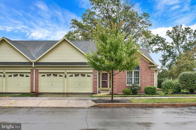 a front view of a house with a garden and garage