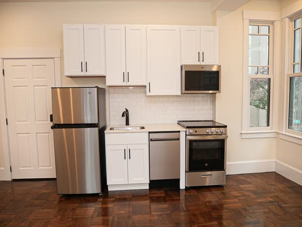 a kitchen with stainless steel appliances a refrigerator sink and microwave
