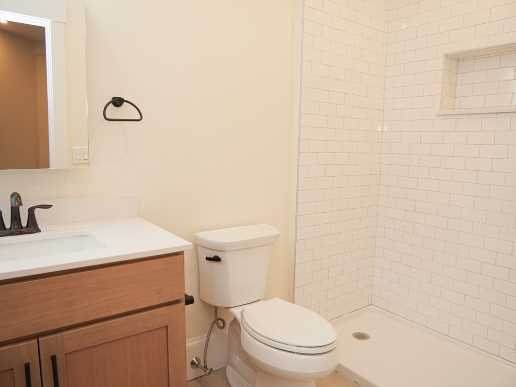 261 West Newton Street, Unit 2 Boston, MA 02116 - Photo 5 of 7 a bathroom with a sink a toilet and a mirror