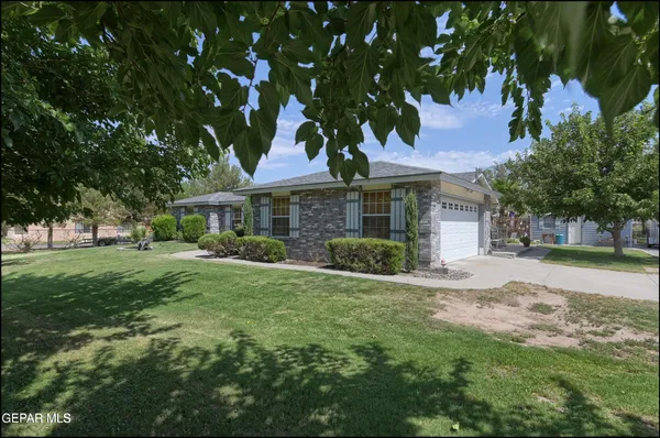 a view of house with outdoor space and garden