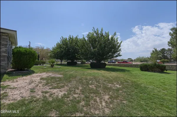 a view of a house with a yard and a garden