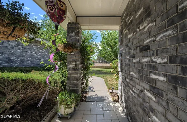 a view of a porch with furniture and garden