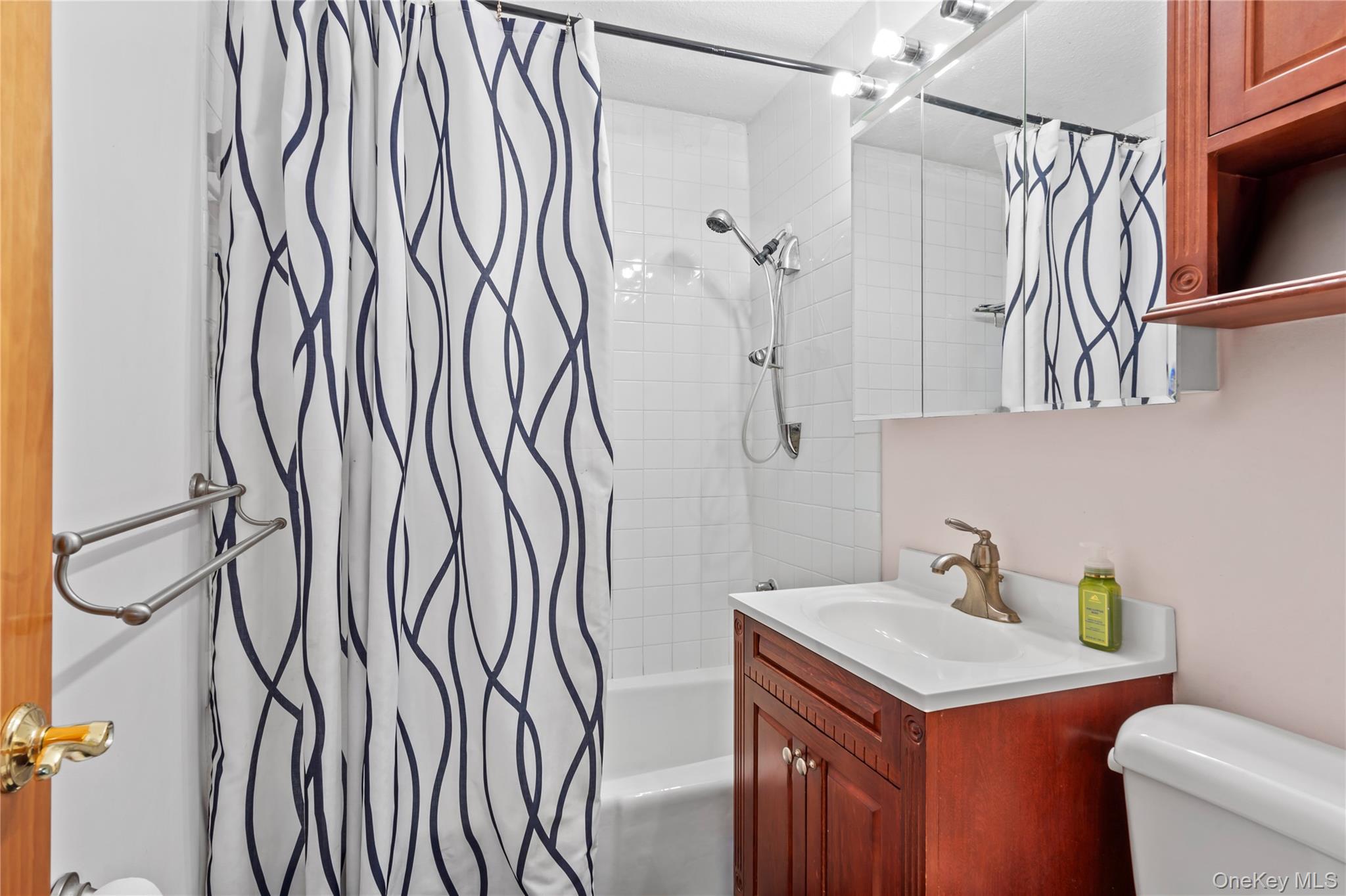 118-18 Union Turnpike, Unit 5F Queens, NY 11415 - Photo 8 of 13 Bathroom with vanity and shower / tub combo with curtain