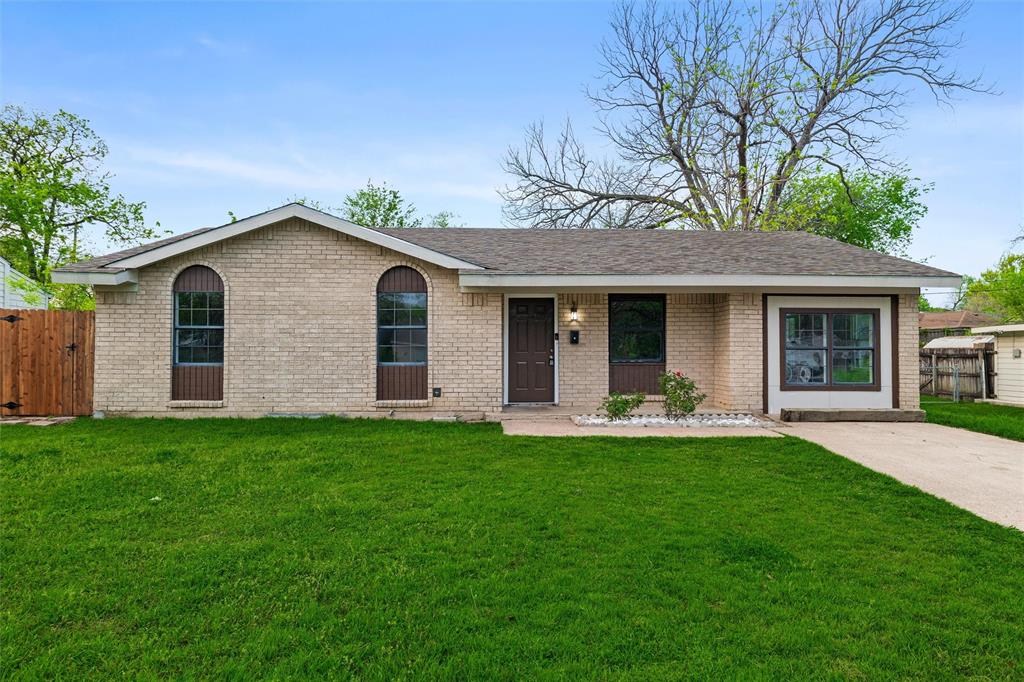 a front view of a house with a garden and yard