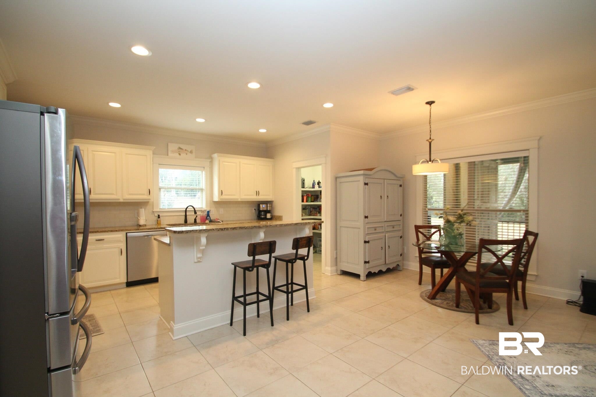 30232 Persimmon Drive Daphne, AL 36527 - Photo 10 of 27 Kitchen with decorative light fixtures, visible vents, appliances with stainless steel finishes, white cabinetry, and a kitchen island