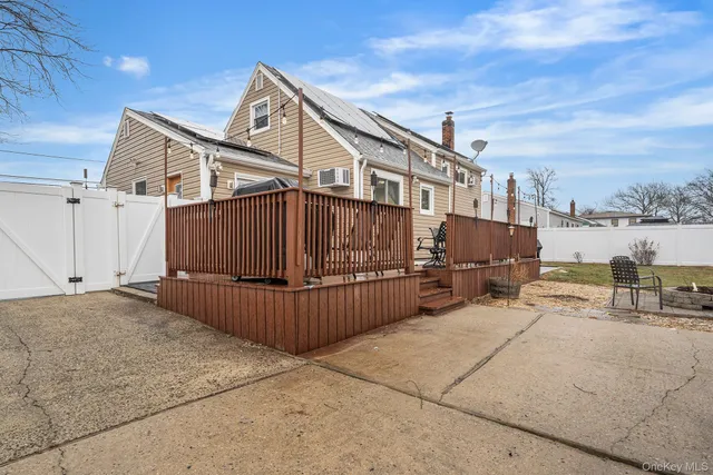 a view of a house with wooden fence