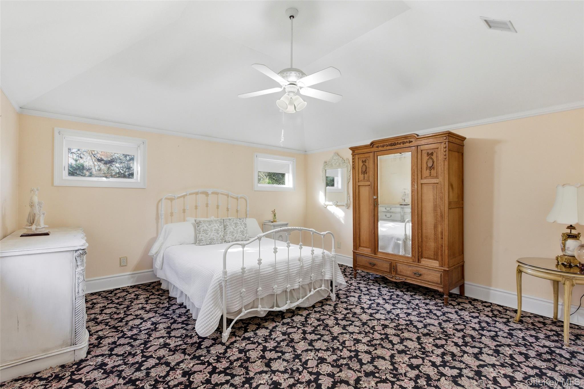 31 West Meadow Road Setauket, NY 11733 - Photo 15 of 28 a bedroom with a bed and a lamp