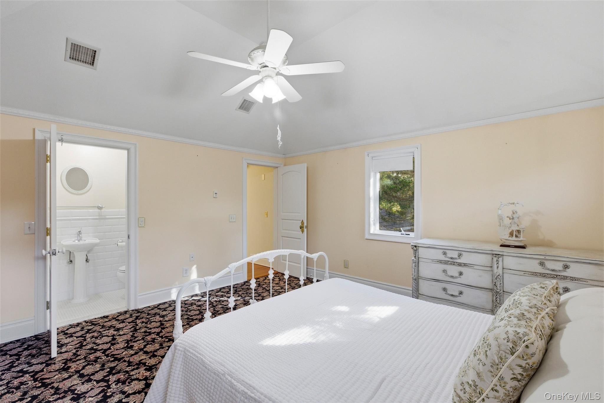 31 West Meadow Road Setauket, NY 11733 - Photo 16 of 28 a bedroom with a bed and a chandelier