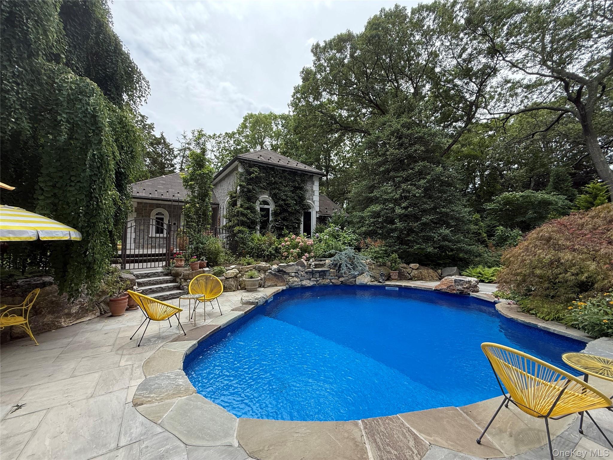 31 West Meadow Road Setauket, NY 11733 - Photo 24 of 28 a view of swimming pool with lounge chair and dinning table under an umbrella