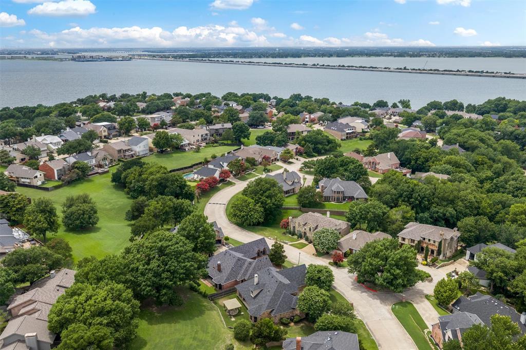5607 Ranger Drive Rockwall, TX 75032 - Photo 4 of 40 Aerial perspective showcasing a residential community with abundant mature trees and curving roadways