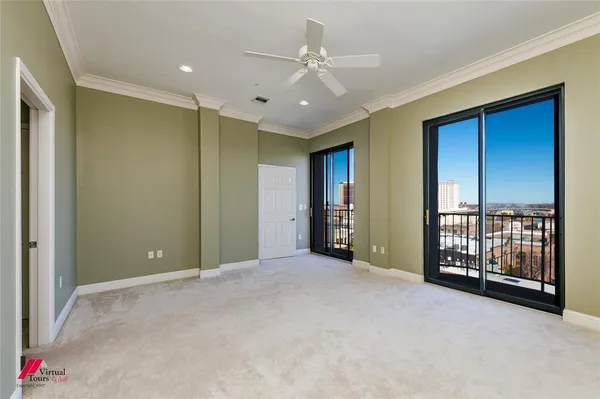 a view of an empty room with a ceiling fan