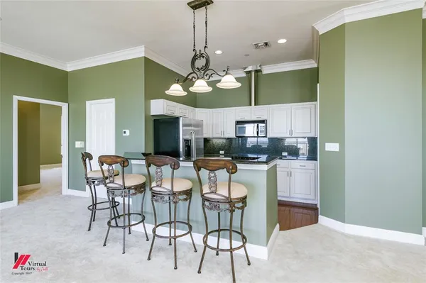 a view of a dining room with furniture and chandelier