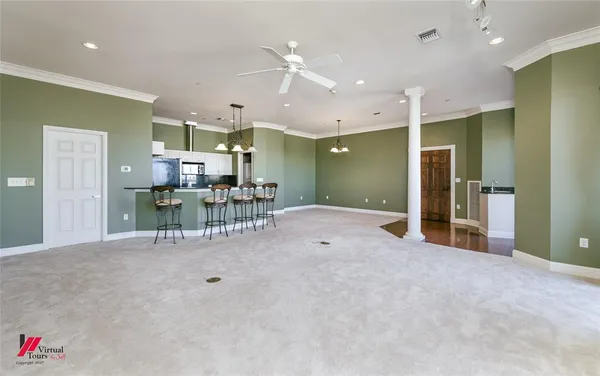 a view of a livingroom with furniture and a ceiling fan