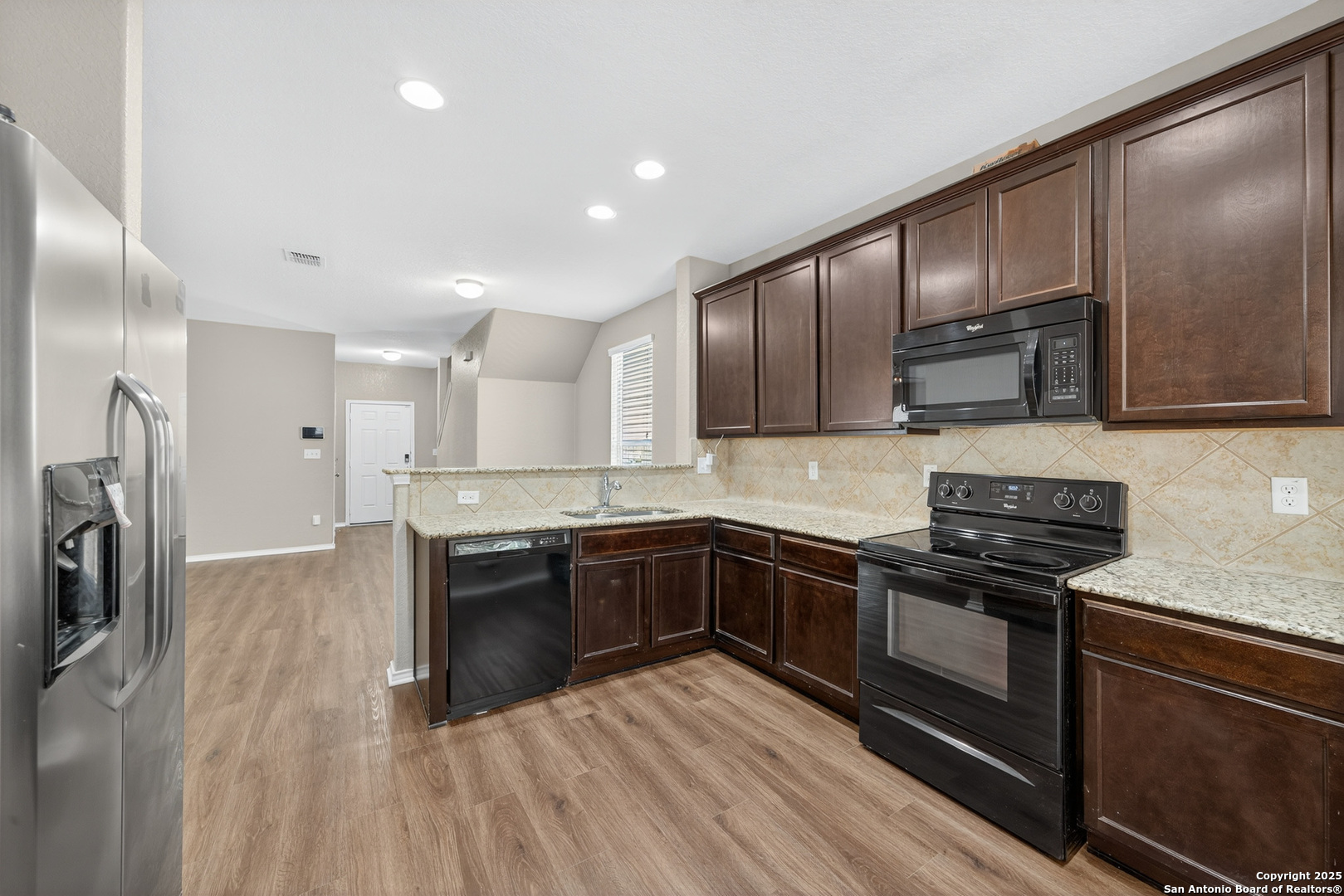 474 Walnut Crest Selma, TX 78154 - Photo 8 of 28 a large kitchen with stainless steel appliances granite countertop a stove and a sink