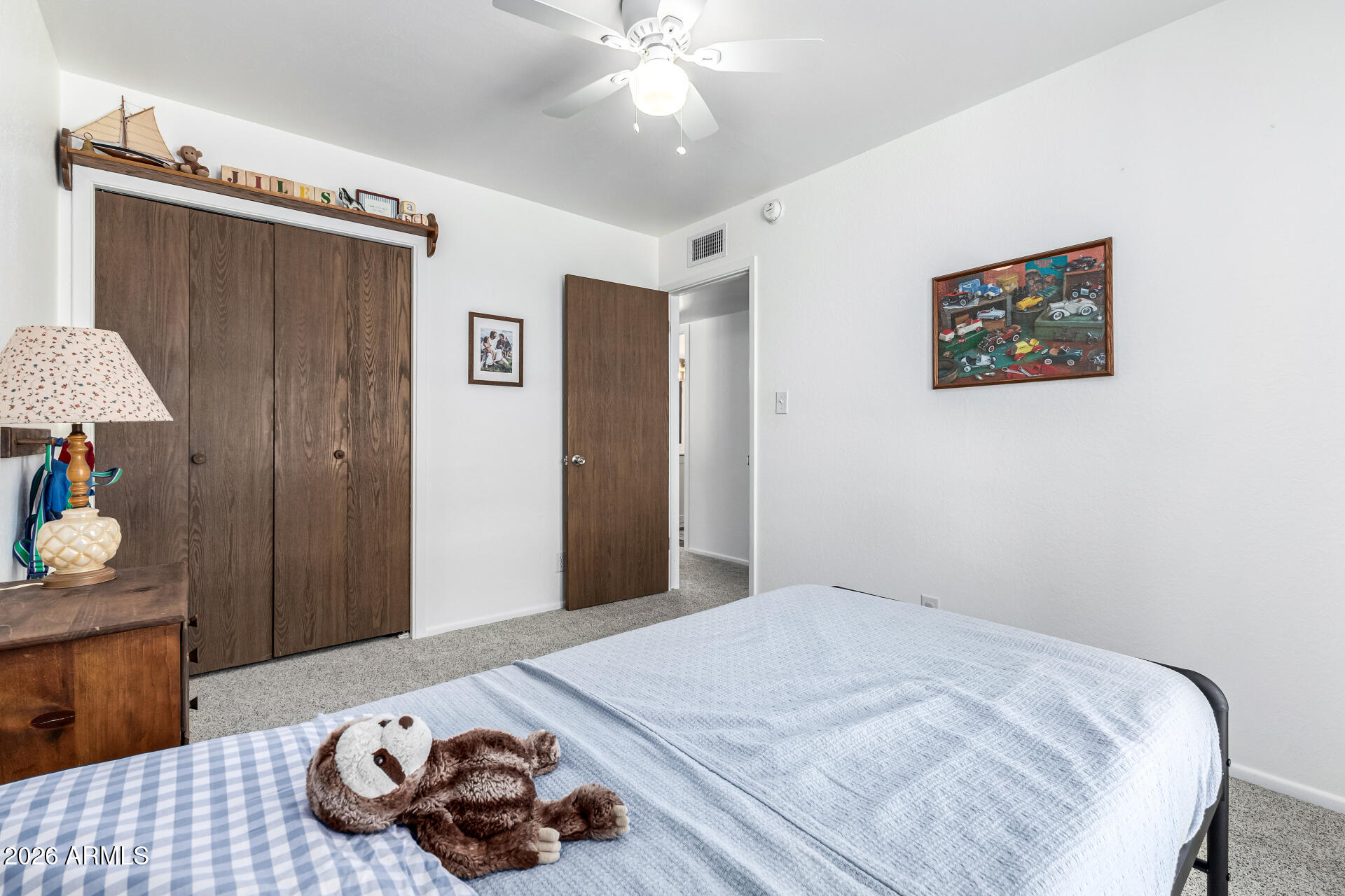 21 South Neely Street Gilbert, AZ 85233 - Photo 18 of 28 a bedroom with a bed and a chandelier