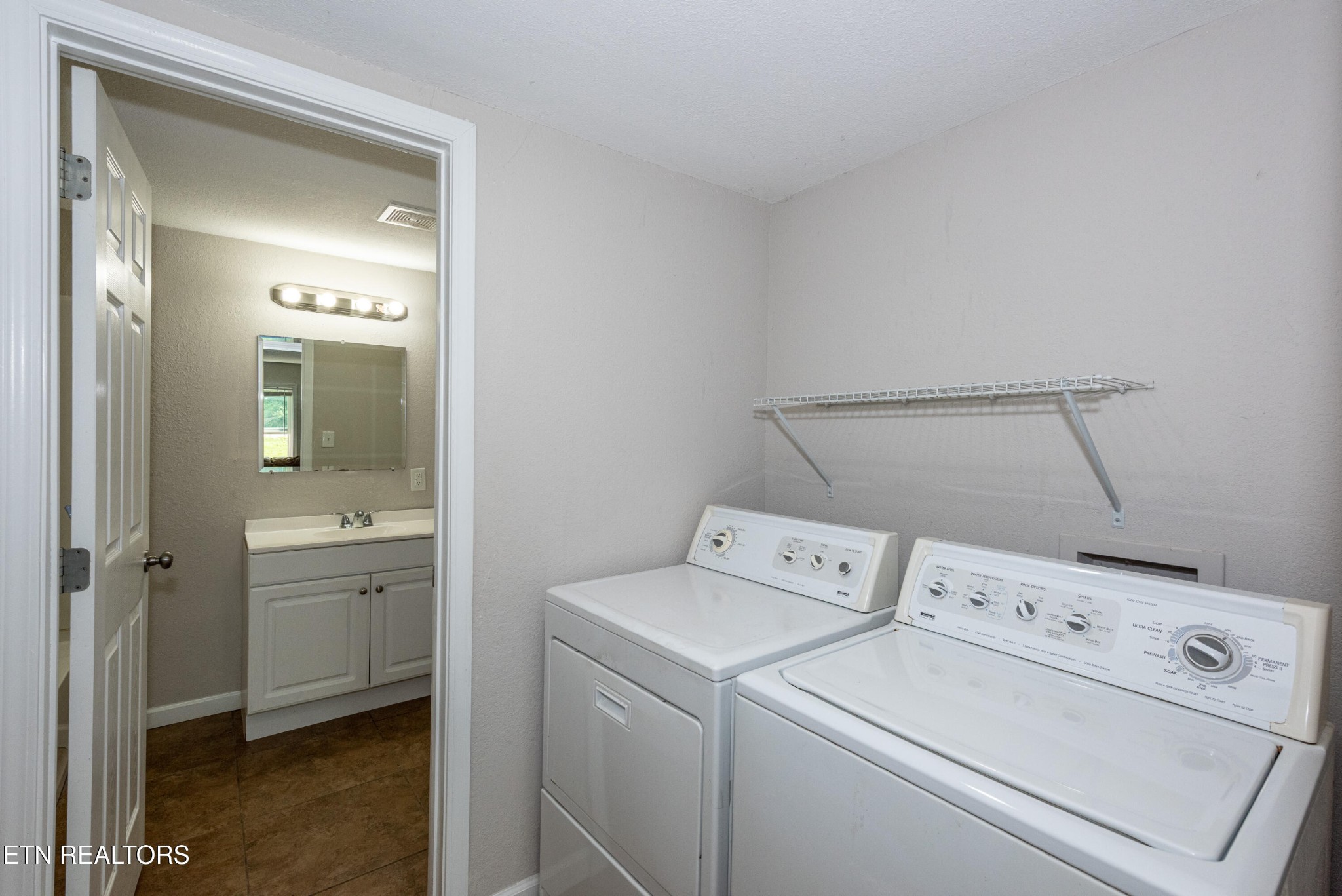 460 Lee Shirley Road Greenback, TN 37742 - Photo 14 of 29 a view of washer and dryer with bathroom in the background