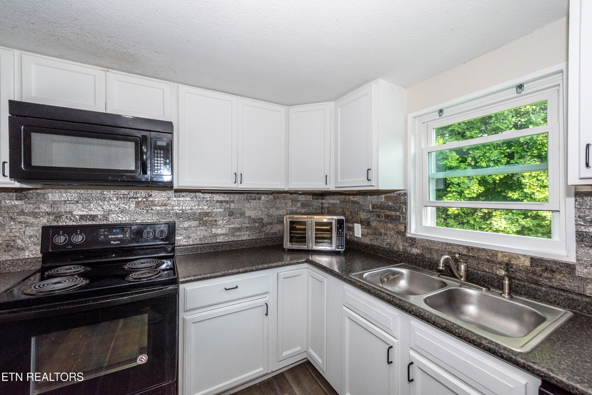 460 Lee Shirley Road Greenback, TN 37742 - Photo 9 of 29 a kitchen with granite countertop white cabinets appliances and a window