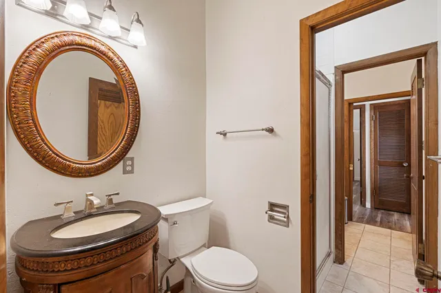 a bathroom with a toilet a sink and a mirror