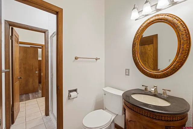 a bathroom with a toilet a sink and a mirror