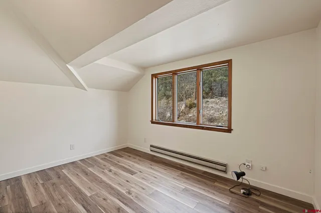 a view of a room with wooden floor and window