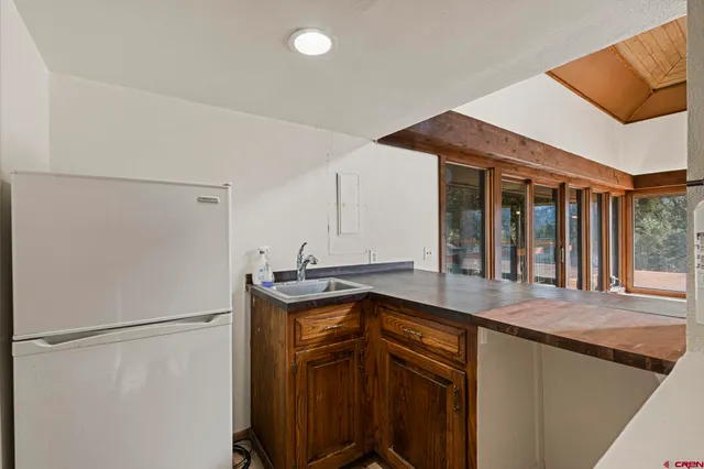 a kitchen with stainless steel appliances a refrigerator and a sink