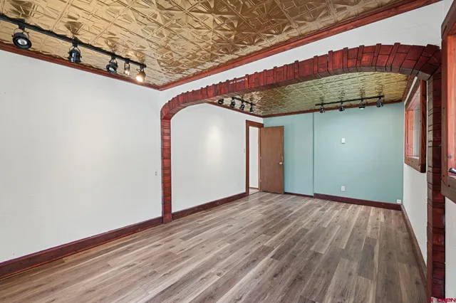 a view of a room with wooden floor and staircase