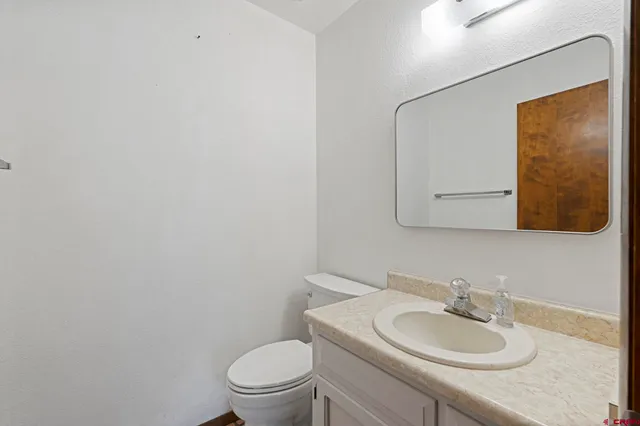 a bathroom with a sink toilet and mirror