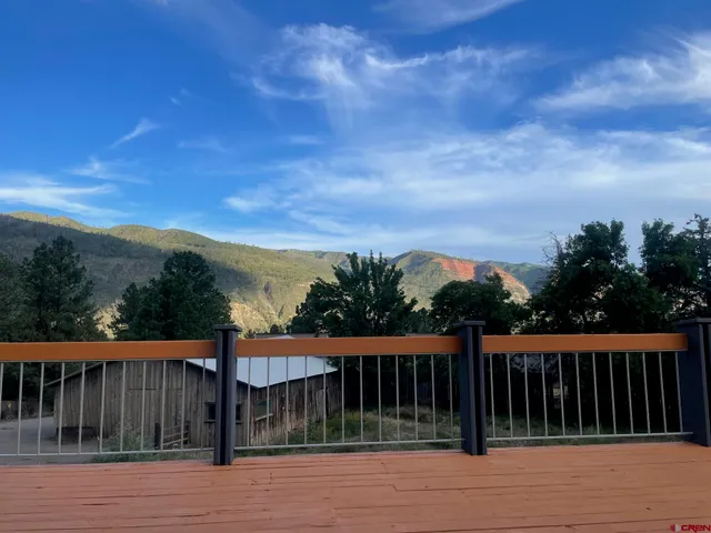 a view of balcony with wooden fence