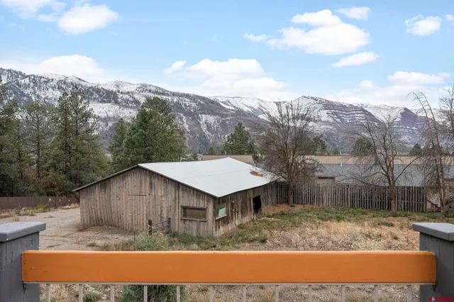 a backyard of a house with large trees