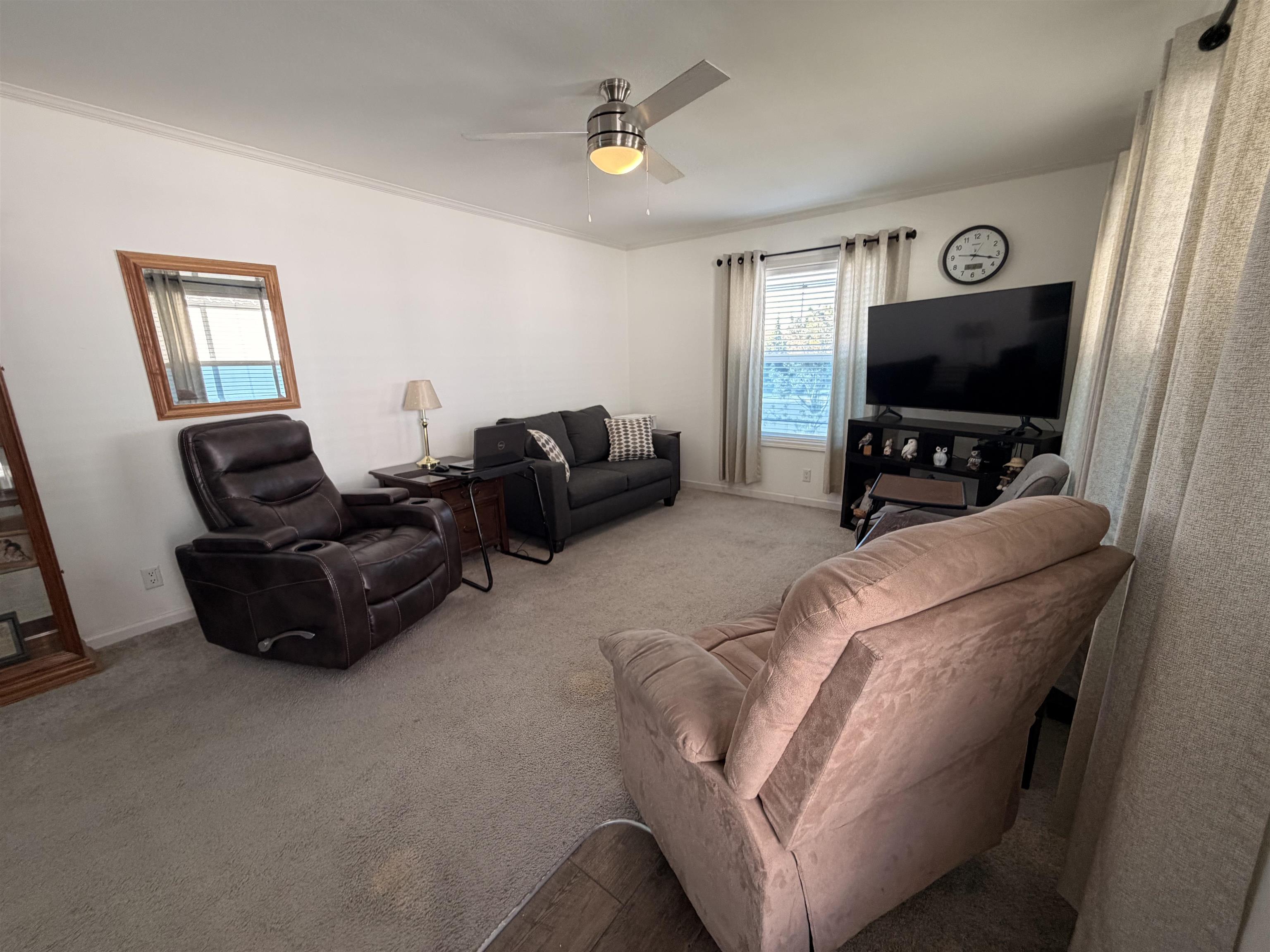 435 32 Road, Unit 826 Clifton, CO 81520 - Photo 2 of 17 a living room with furniture and a flat screen tv