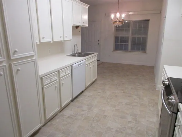 a kitchen with cabinets and window
