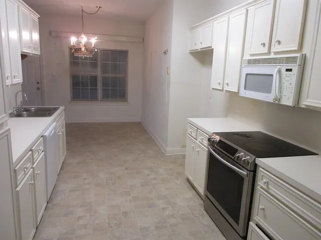 a kitchen that has a sink and a stove