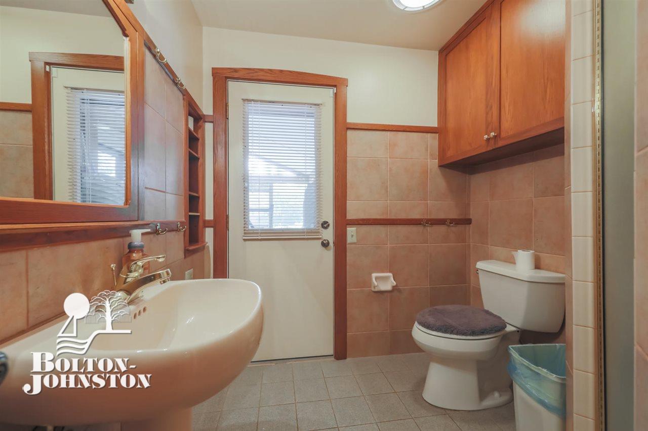 1067 Devonshire Road Grosse Pointe, MI 48230 - Photo 23 of 58 First floor bath...which is off the hall and the enclosed screen porch acting as the pool house cabana.