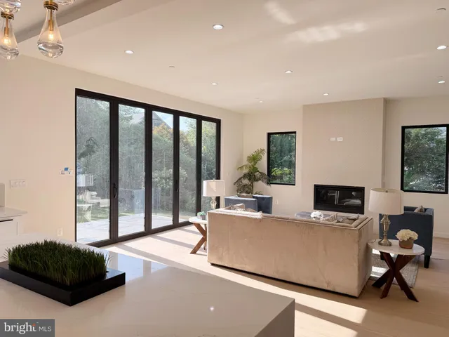 a living room with a couch a large window and a flat screen tv