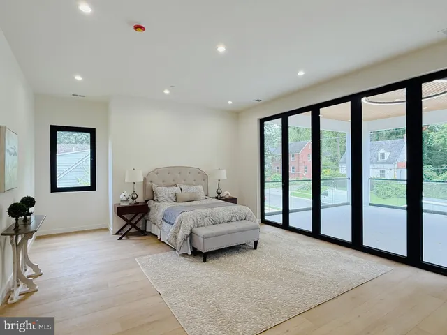 a spacious bedroom with a large bed and a large window