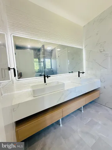 a bathroom with a double vanity sink and mirror