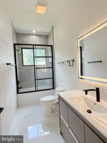 a bathroom with a sink toilet and mirror