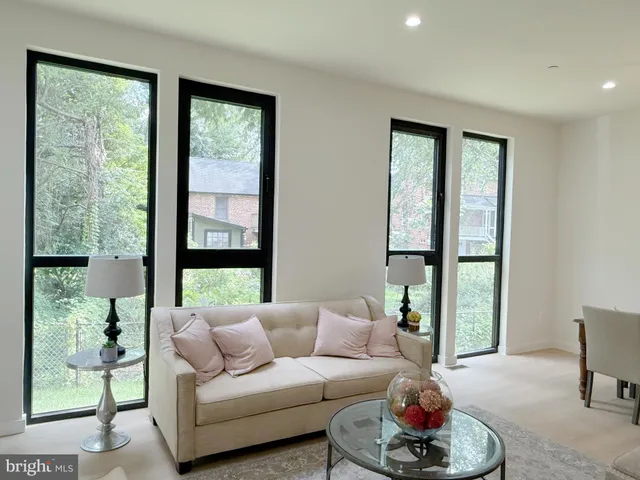 a living room with furniture and a painting on the wall