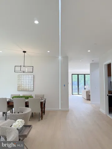 a large white kitchen with cabinets and refrigerator