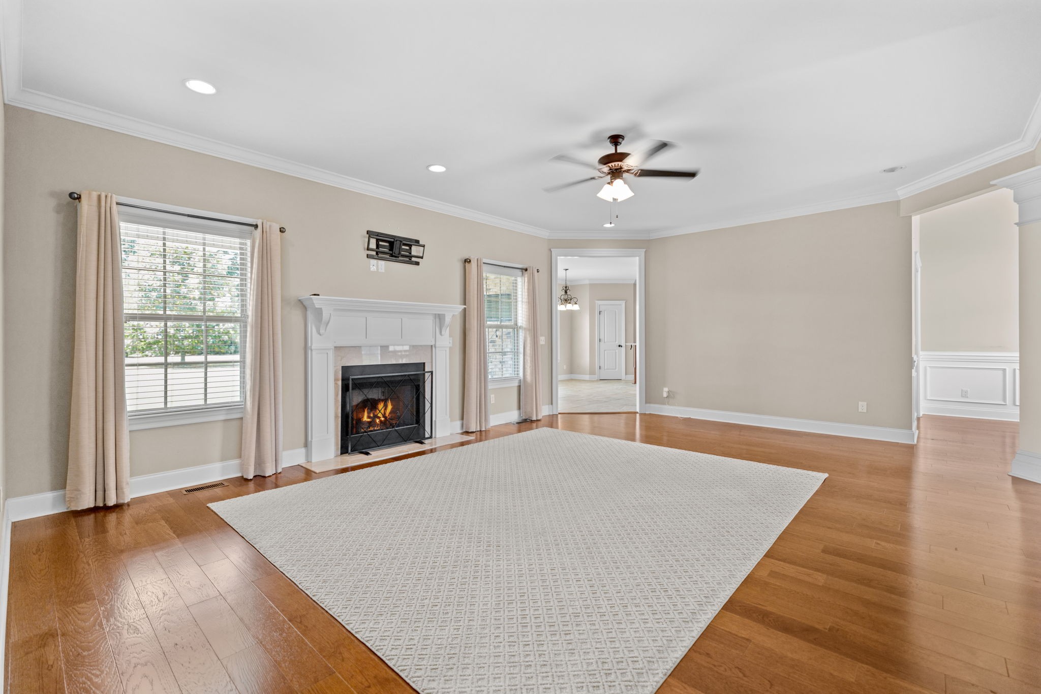 201 Hunters Ridge Drive Tullahoma, TN 37388 - Photo 3 of 45 a view of an empty room with chandelier fan and wooden floor