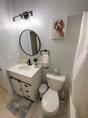 a bathroom with a toilet a sink and mirror
