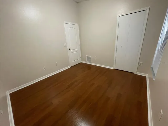 an empty room with wooden floor