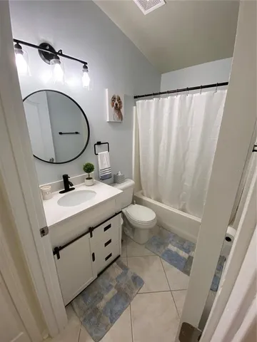 a bathroom with a sink mirror and vanity